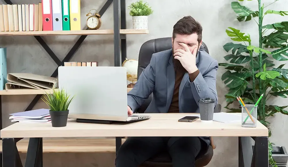 disappointed executive leader sitting in chair reflecting on hiring failure and recruitment challenges