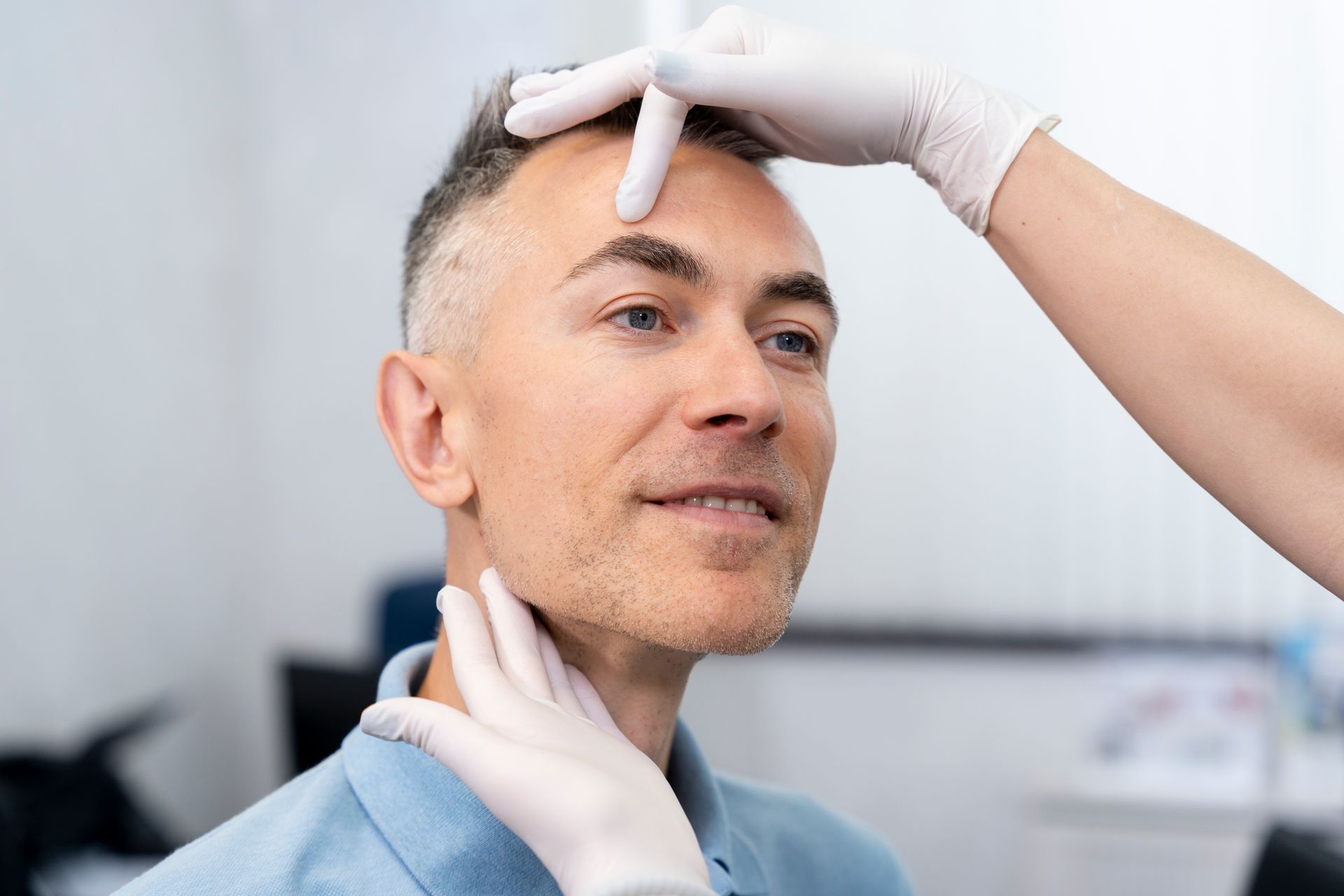 A man is getting his face examined by a doctor.