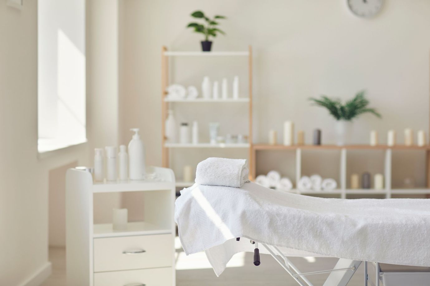 There is a massage table in the middle of the room.
