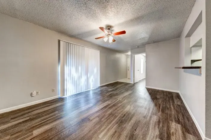 Living room with grey floors and ceiling fan