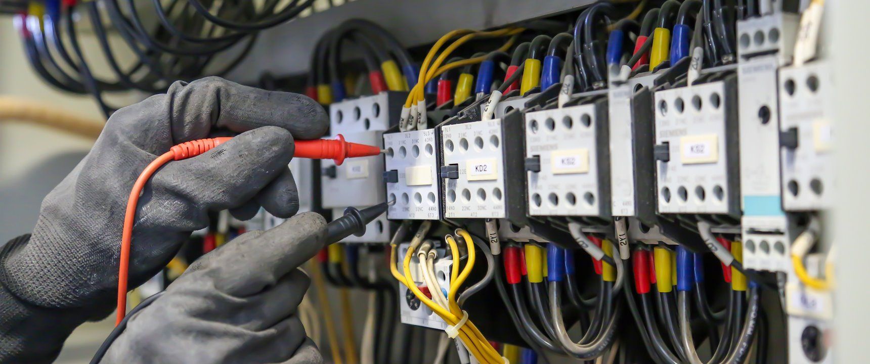 An Electrician is Working on an Electrical Box With a Multimeter — Goat Collective in Kyogle, NSW