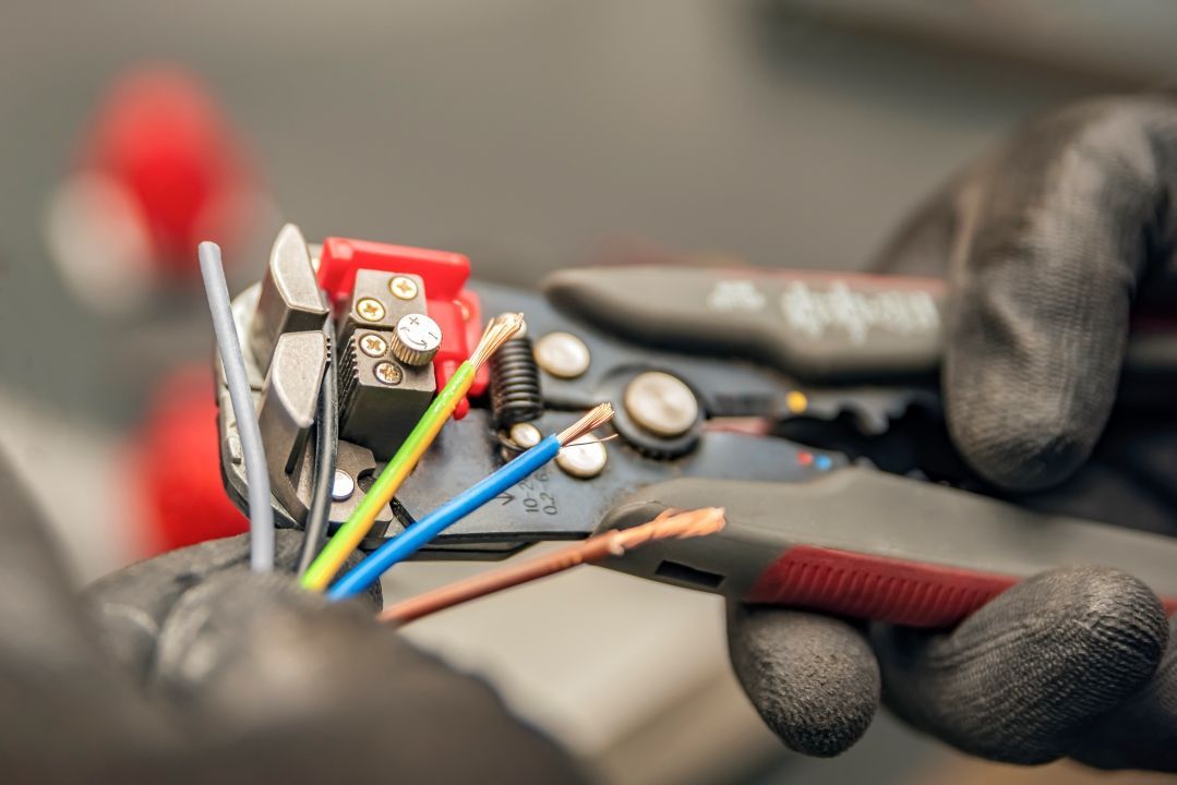 A Person is Cutting Wires With a Wire Stripper — Goat Collective in Ballina, NSW