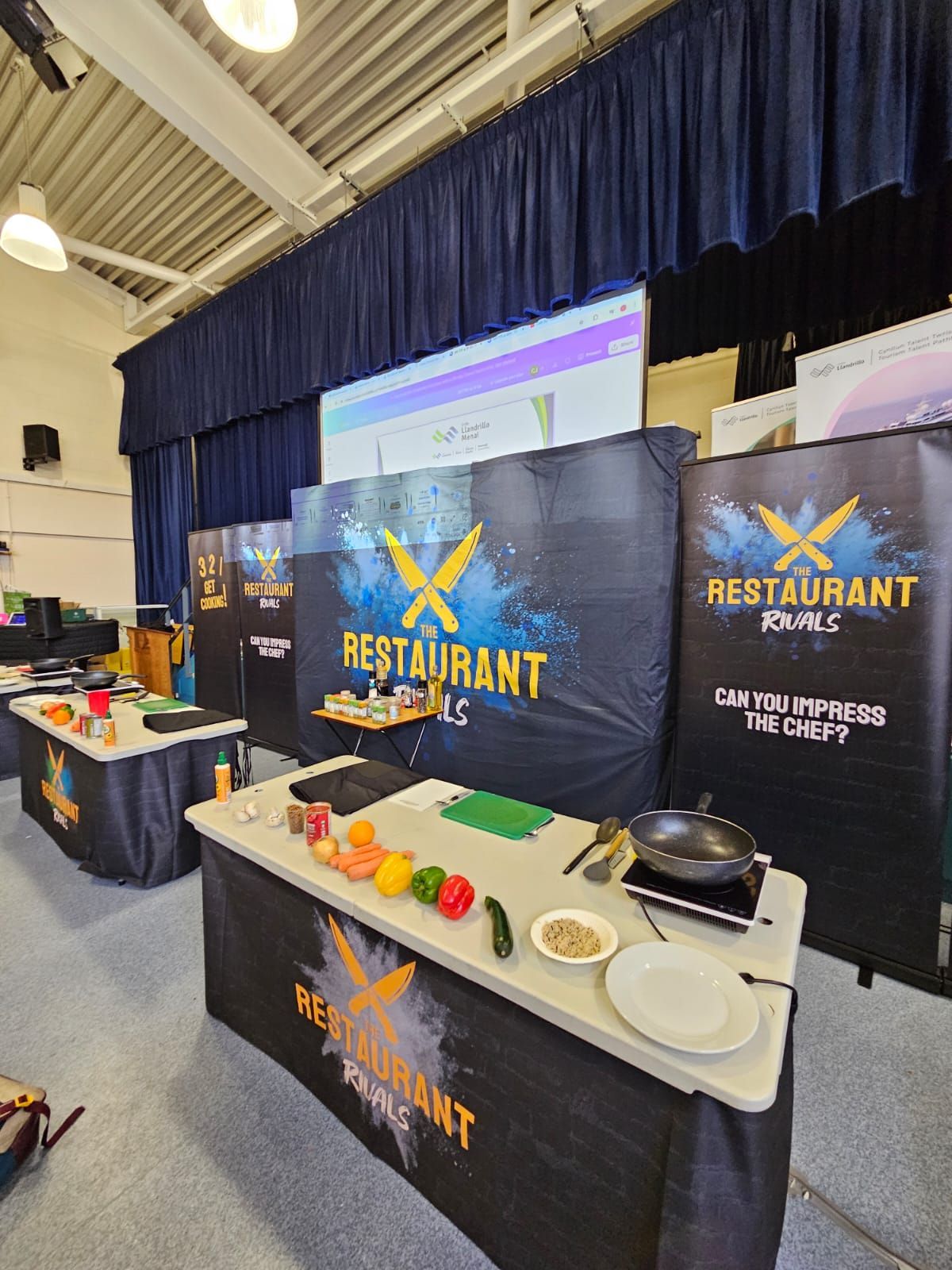 Cooking demonstration setup with tables, ingredients, and 