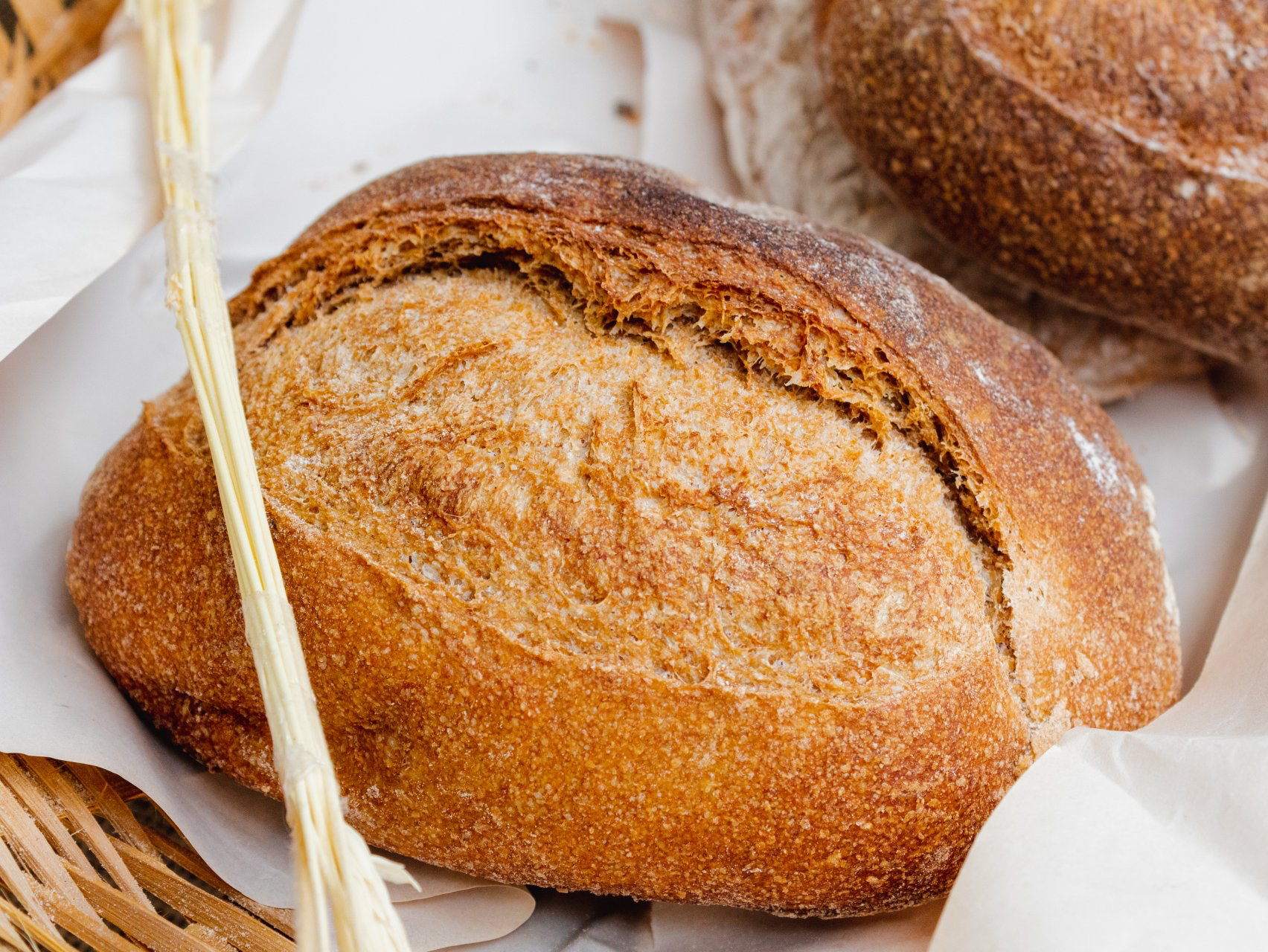 Round loaf of bread on white paper.