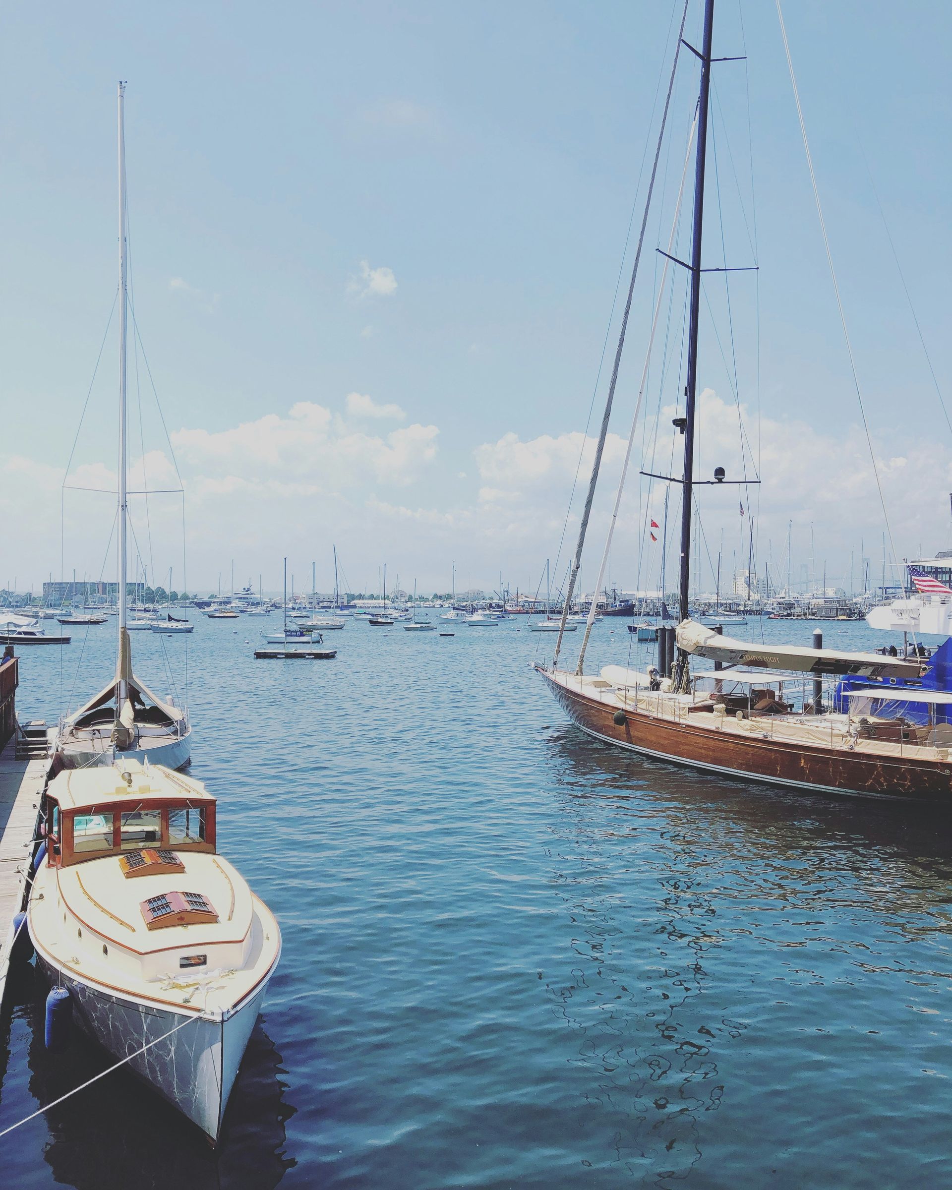 A couple of boats are docked at a dock in the water.