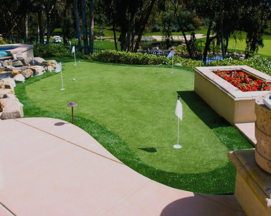 Aerial view of a house with a backyard pool, lawn, and large concrete pad in a rural area