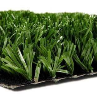 Artificial turf grass mat with dense green blades on a black backing