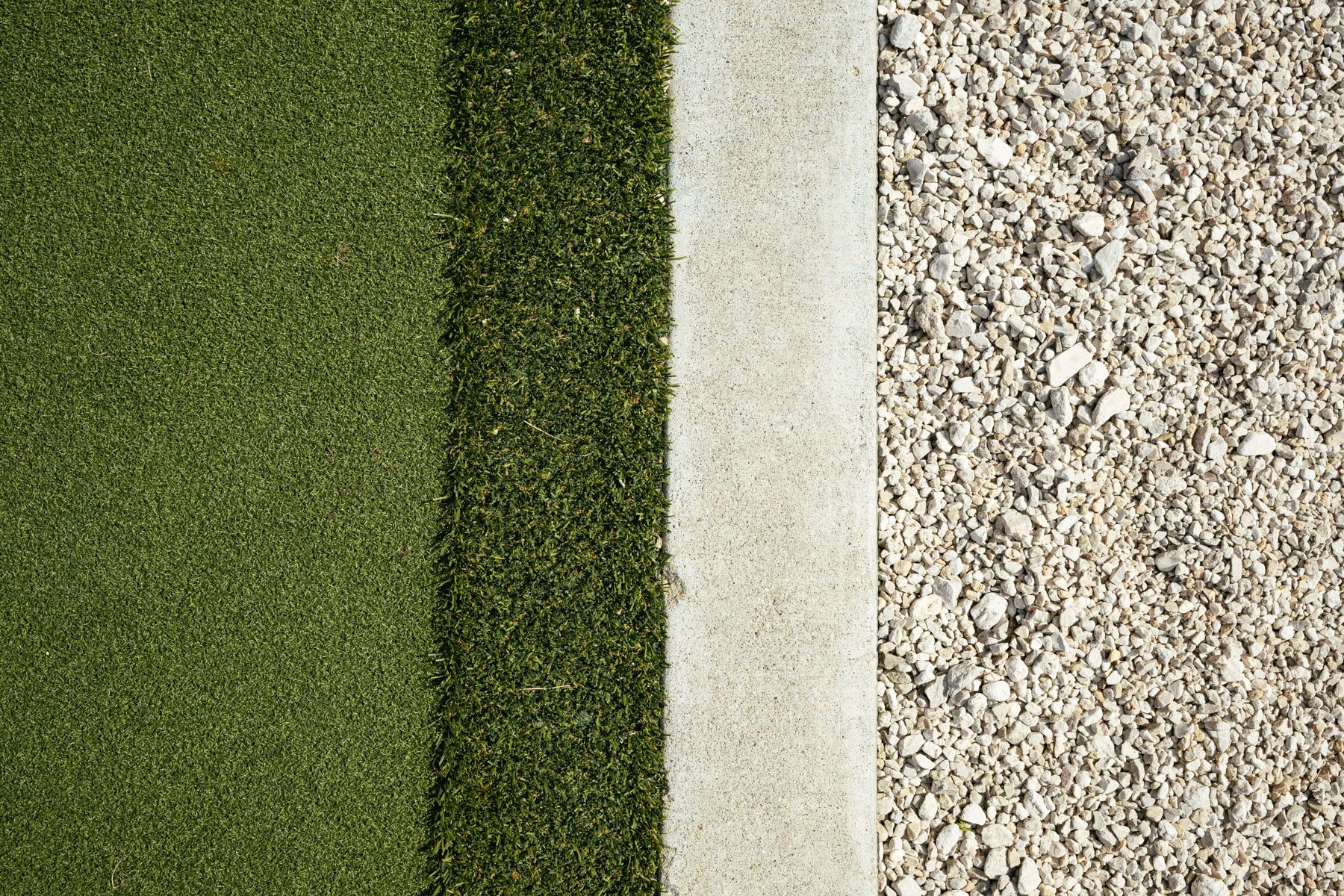 Abstract close-up of four vertical textured surface strips in green, dark green, white, and beige tones