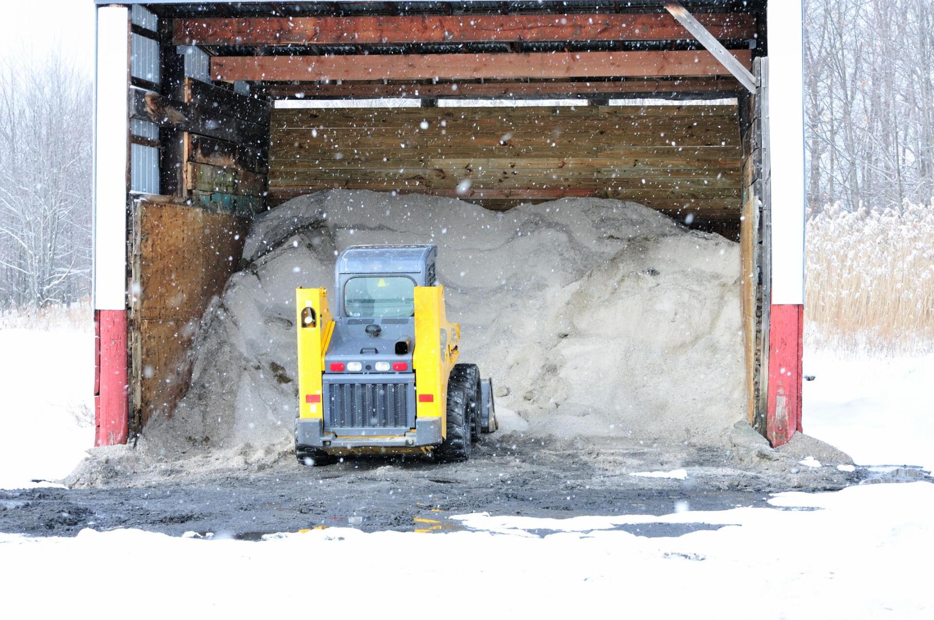 small bulldozer shaving the snow