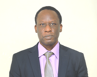 A man in a suit and tie is looking at the camera