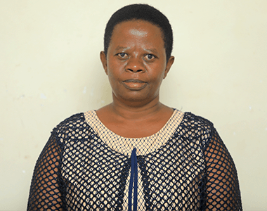 A woman with short hair is wearing a black and white dress