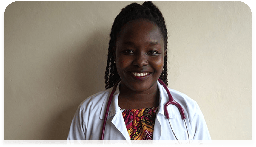 A woman in a lab coat with a stethoscope around her neck is smiling.