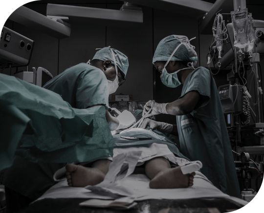 Two surgeons are operating on a patient in an operating room.
