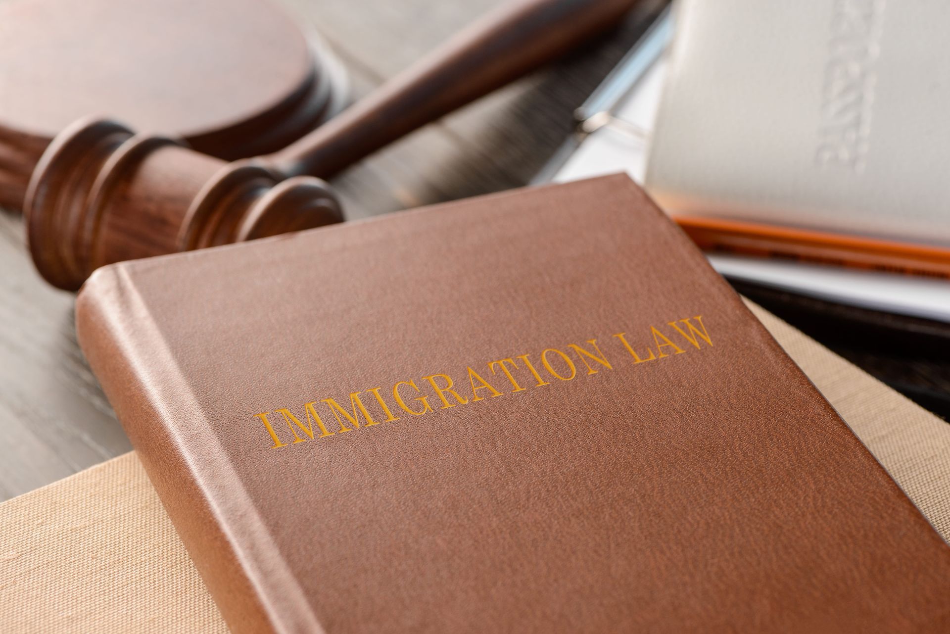 Brown leather legal codebook with a gavel and books in the background