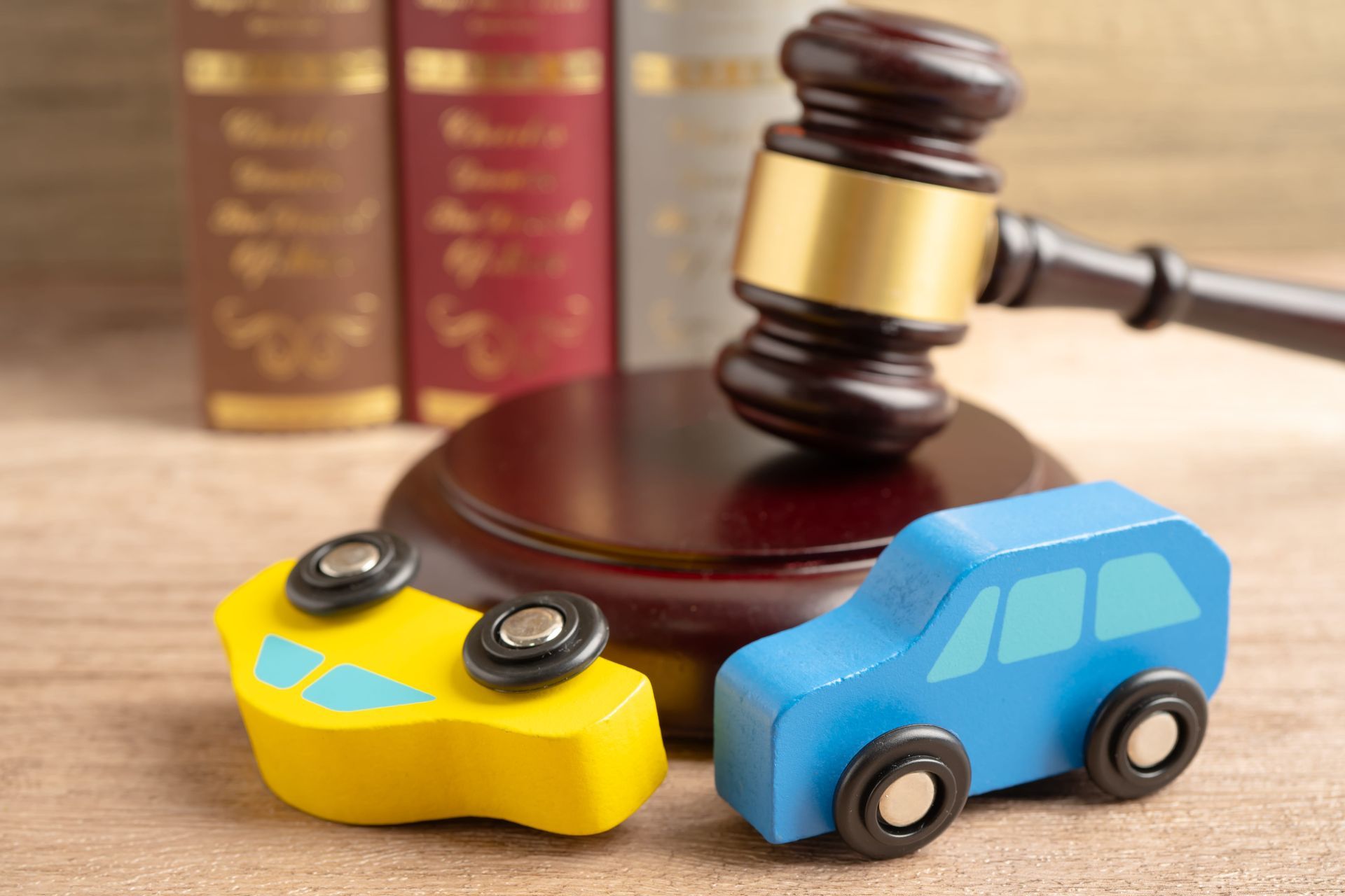 Toy car and game controller beside a judge’s gavel, symbolizing a legal case over a crash