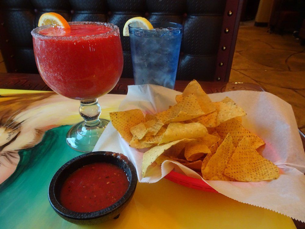 Frozen strawberry margarita, blue drink, tortilla chips with salsa.