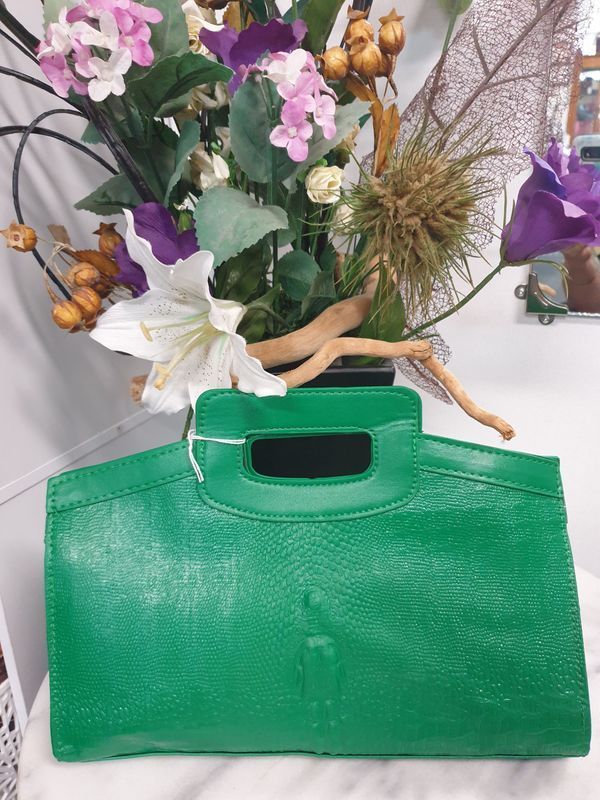Bright Green Handbag With a Rectangular Handle, in Front of a Flower Arrangement — Shona's Lingerie in Hermit Park, QLD