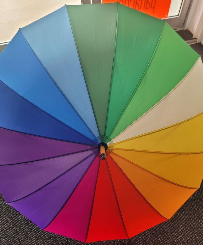 Open, Rainbow-coloured Umbrella With Wood Handle — Shona's Lingerie in Hermit Park, QLD