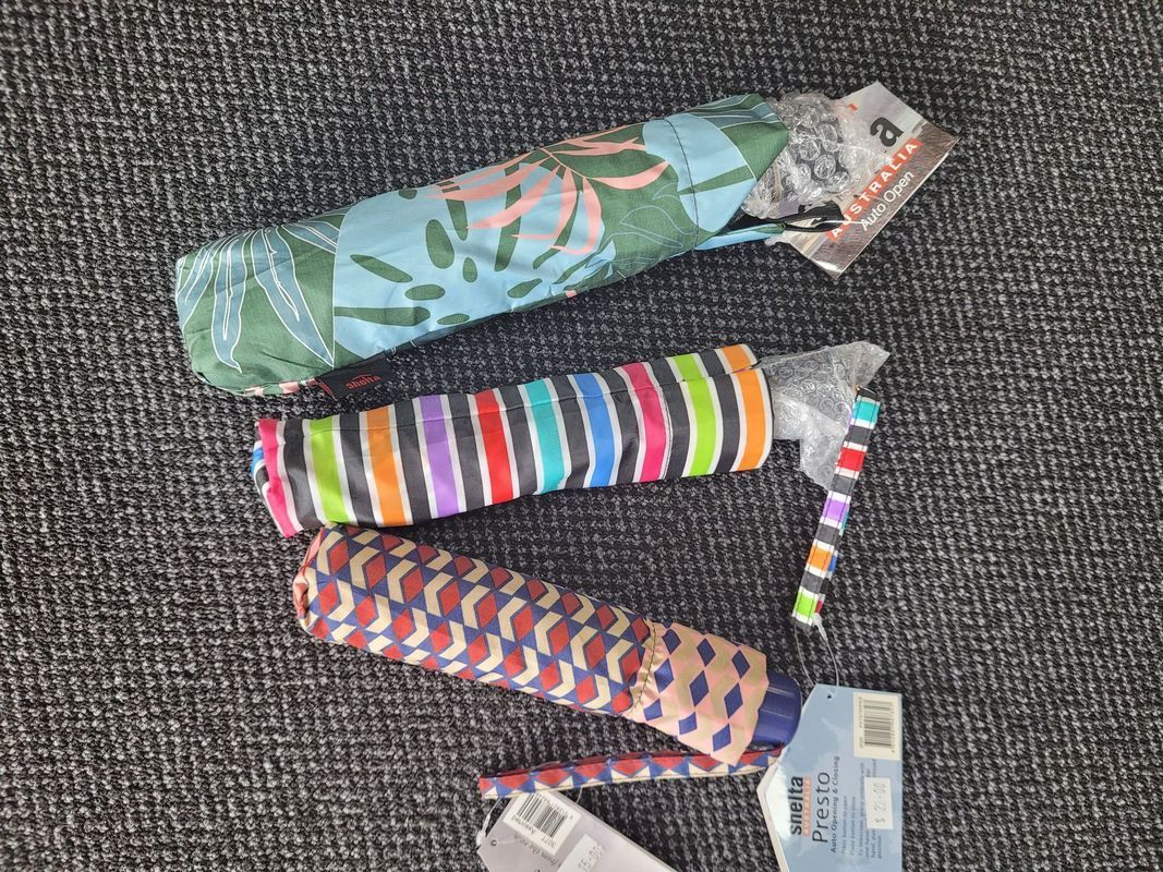 Three Rolled-up Umbrellas With Colorful Patterns — Shona's Lingerie in Hermit Park, QLD