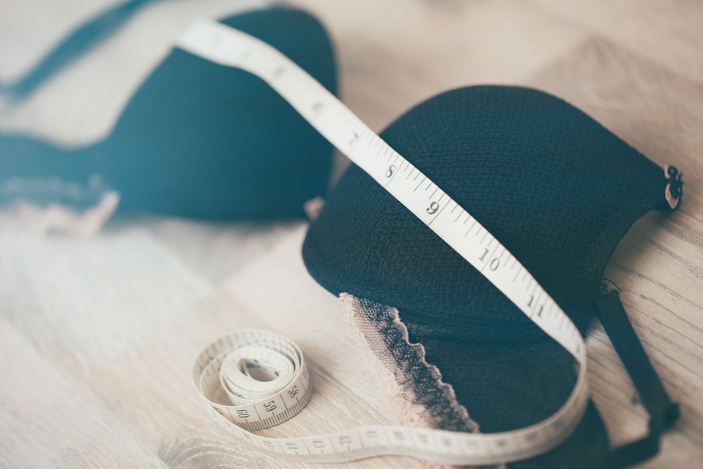 Black Bra With Measuring Tape on Wooden Surface — Shona's Lingerie in Annadale, QLD