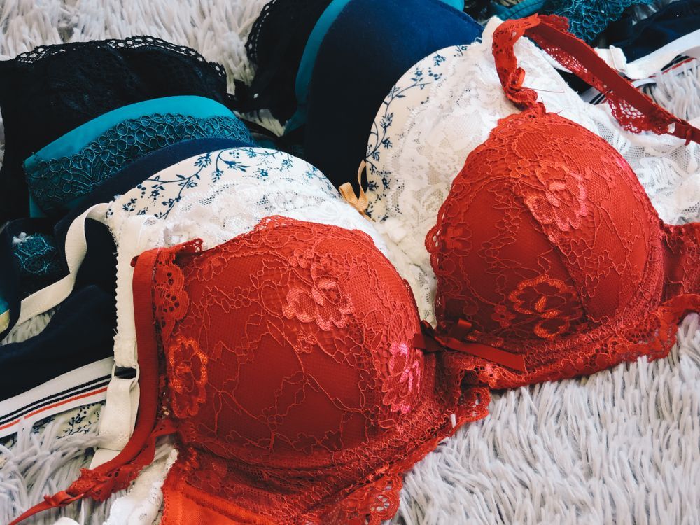 Pile of Various Colorful Bras on a Textured Surface — Shona's Lingerie in Annadale, QLD