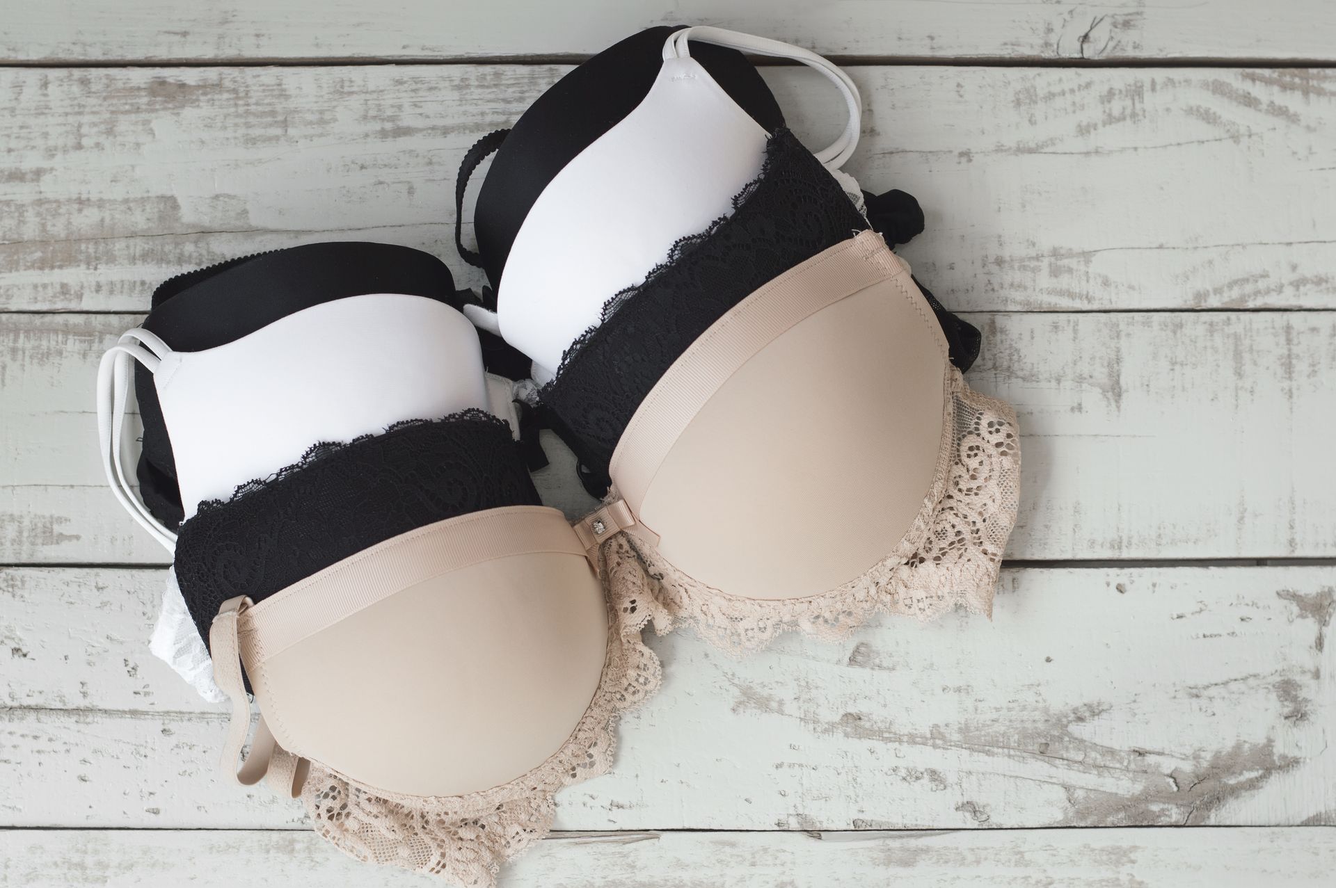 Pile of Bras in Various Colors: White, Black, and Beige — Shona's Lingerie in Hermit Park, QLD