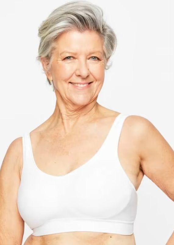 Woman With Gray Hair Smiling, Wearing a White Sports Bra — Shona's Lingerie in Hermit Park, QLD