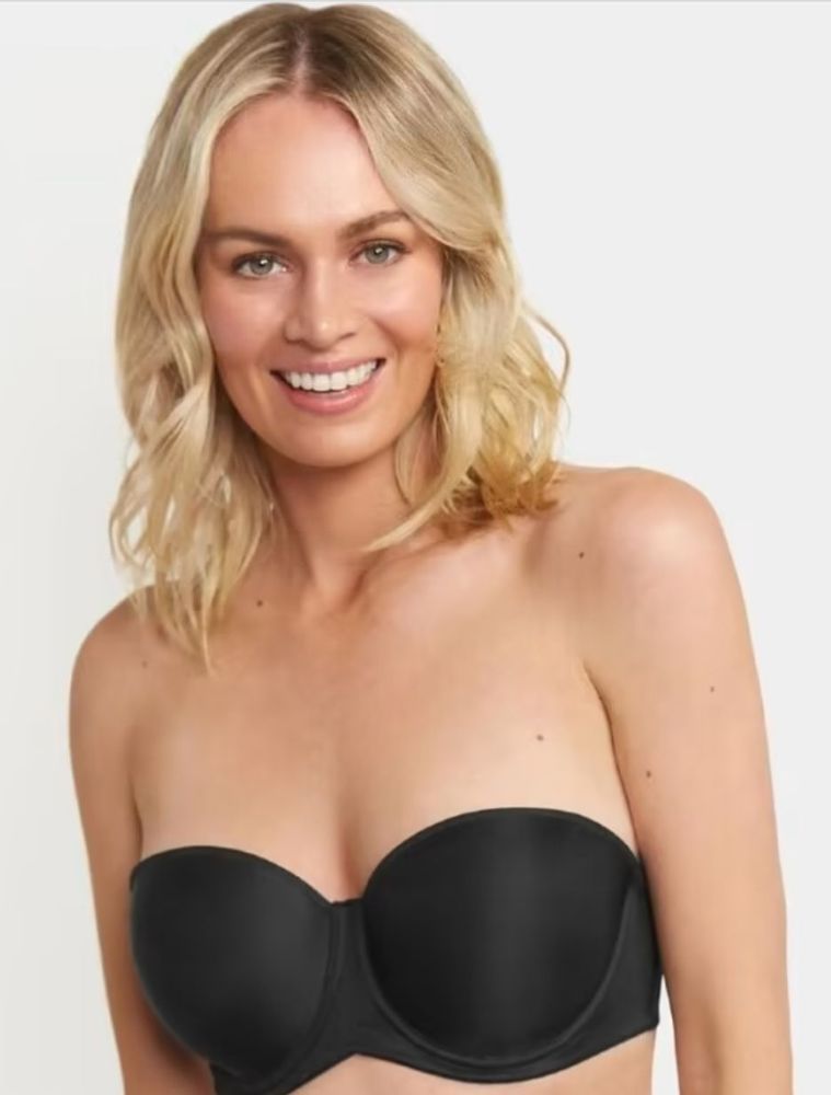 Woman With Blonde Hair Smiling, Wearing a Black Strapless Bra — Shona's Lingerie in Hermit Park, QLD