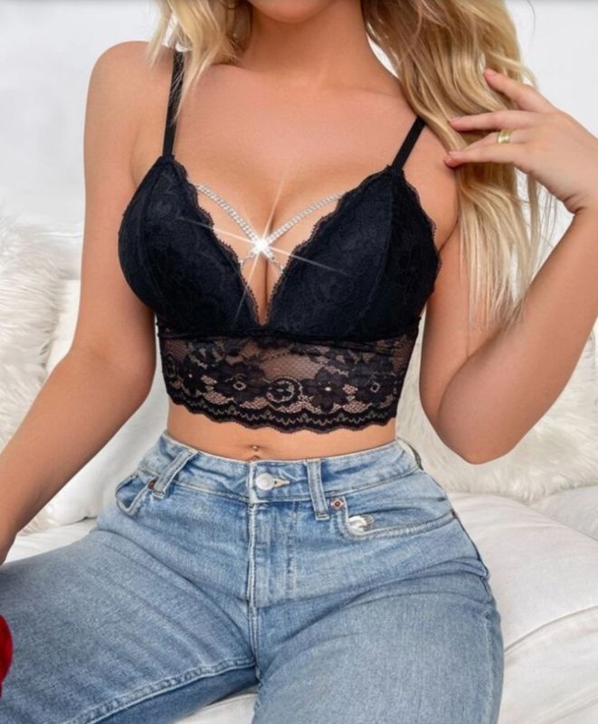Woman in Black Lace Crop Top, Blue Jeans, Hand Near Face — Shona's Lingerie in Hermit Park, QLD