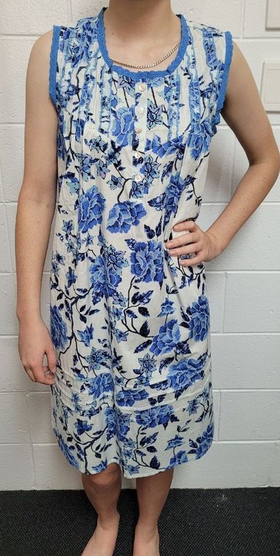 Person Wearing a Sleeveless Floral Blue and White Dress, Hand on Hip — Shona's Lingerie in Hermit Park, QLD