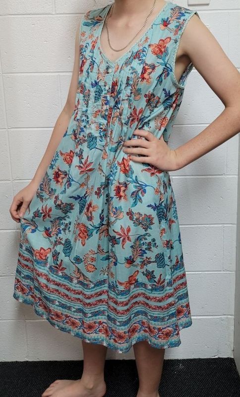 Woman in a Floral, Sleeveless, Light Blue Dress, Hand on Hip — Shona's Lingerie in Hermit Park, QLD