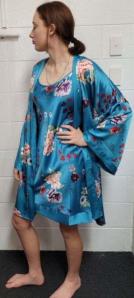 Woman Wearing a Teal Floral Patterned Silk Robe and Matching Slip Dress — Shona's Lingerie in Hermit Park, QLD