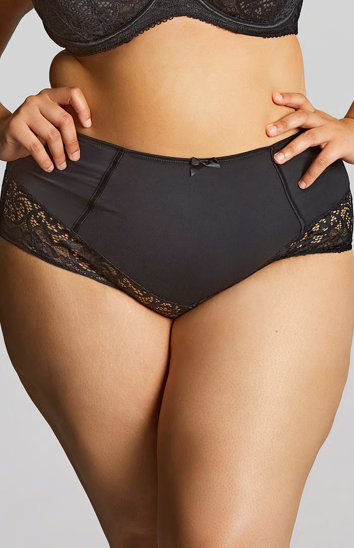 Woman in Black Activewear Holding a Spiky Massage Ball Against Her Thigh — Shona's Lingerie in Hermit Park, QLD