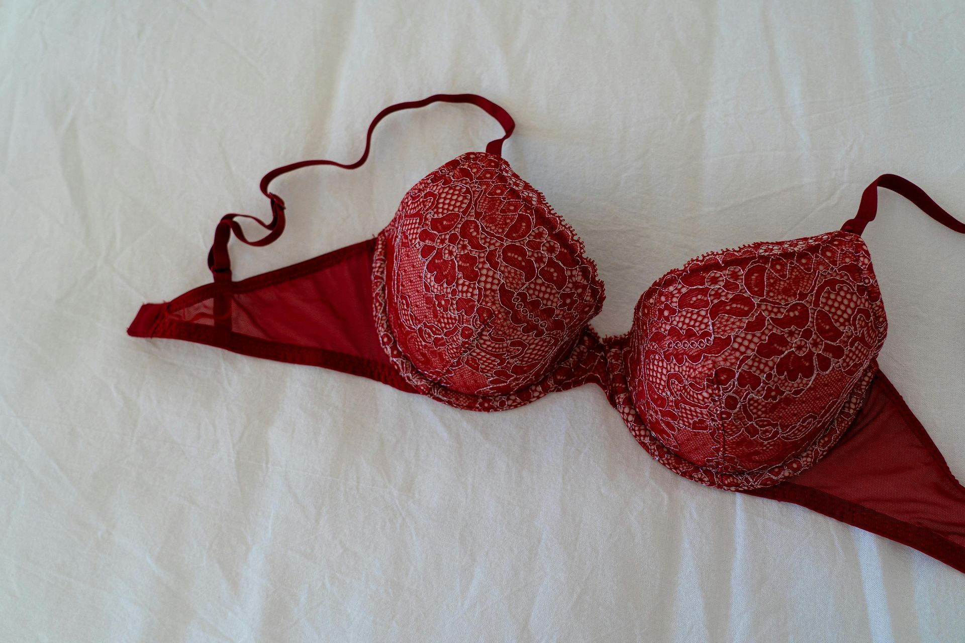 Red Lace Bra on White Fabric — Shona's Lingerie in Rasmussen, QLD