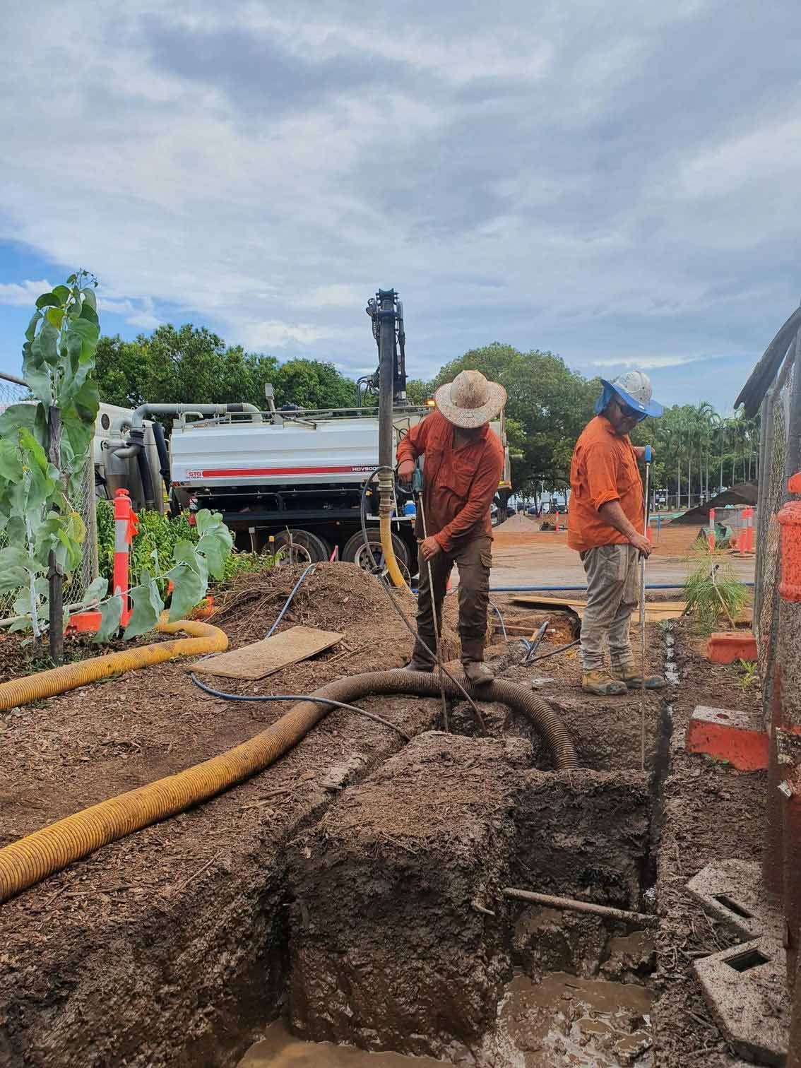 Two Workers Digging a Trench, Near a Truck and Some Vegetation — Austar Underground Services in Girraween, NT
