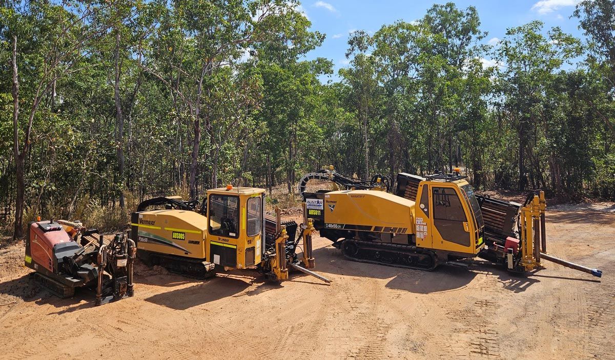Three Yellow Directional Drilling Machines on a Dirt Road — Austar Underground Services in Girraween, NT