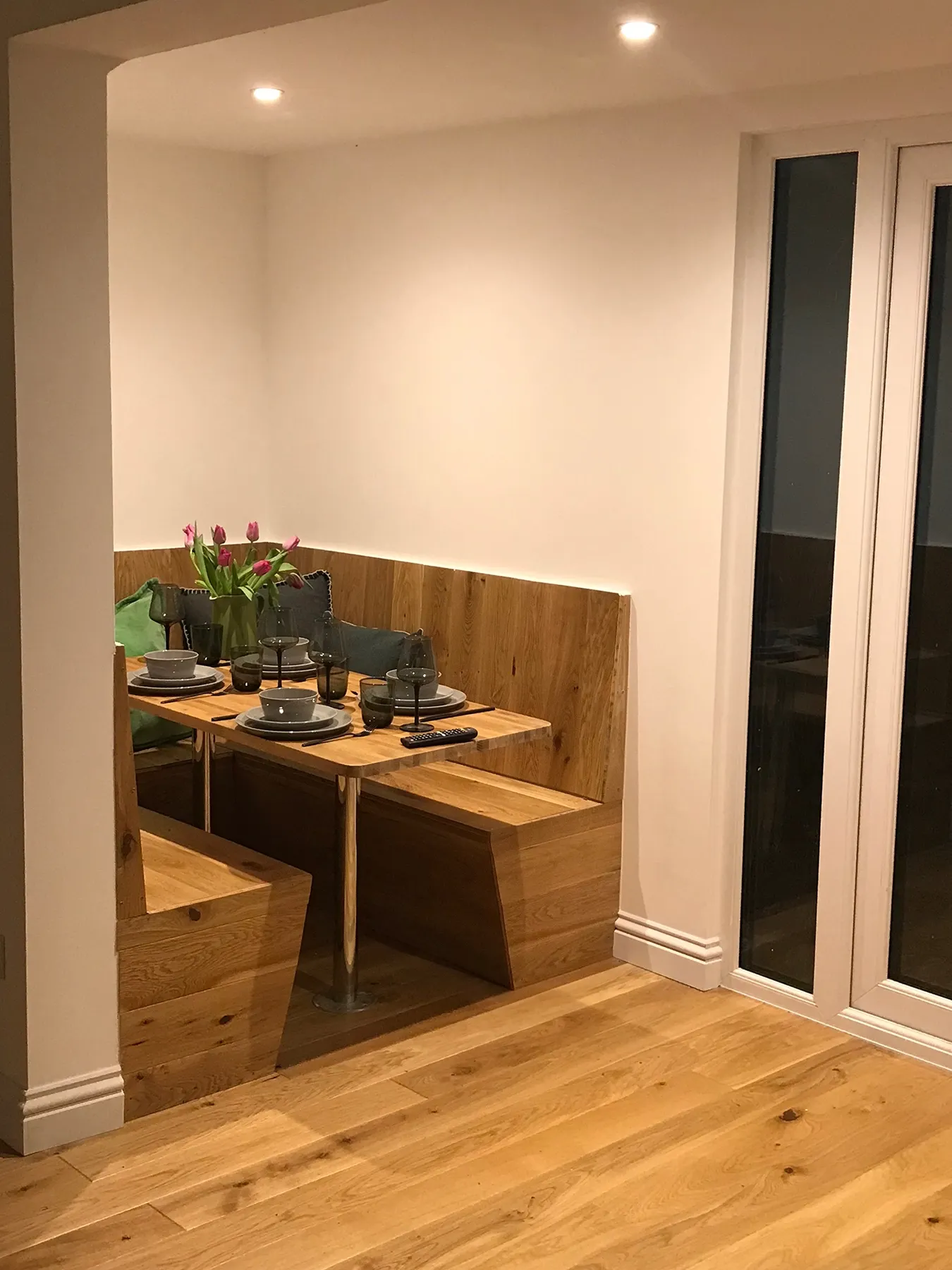 A Timber Garden Room furnished as dining room with a wooden table and benches.