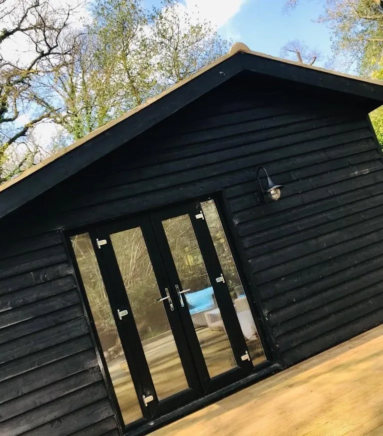 A Timber Garden Room with windows and doors