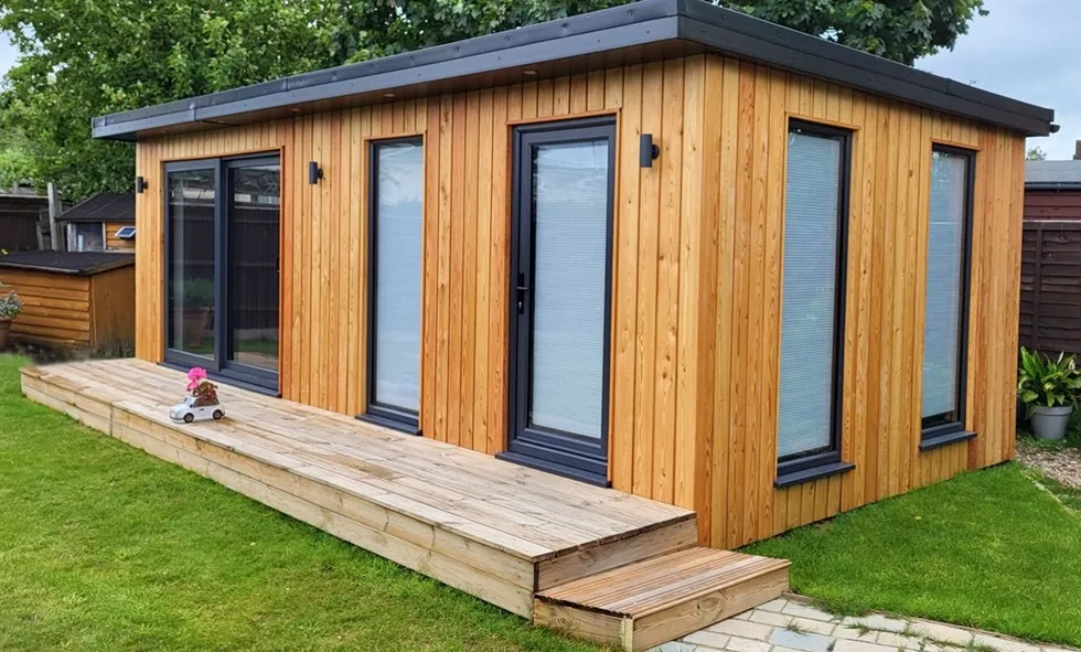 A Timber Garden Room with a deck in the backyard.