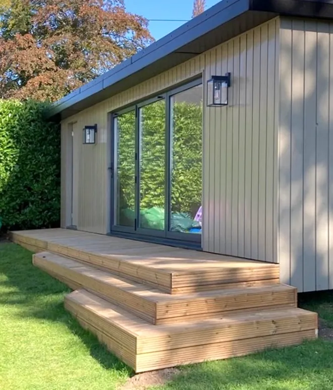 A house with a wooden deck and stairs in front of it.