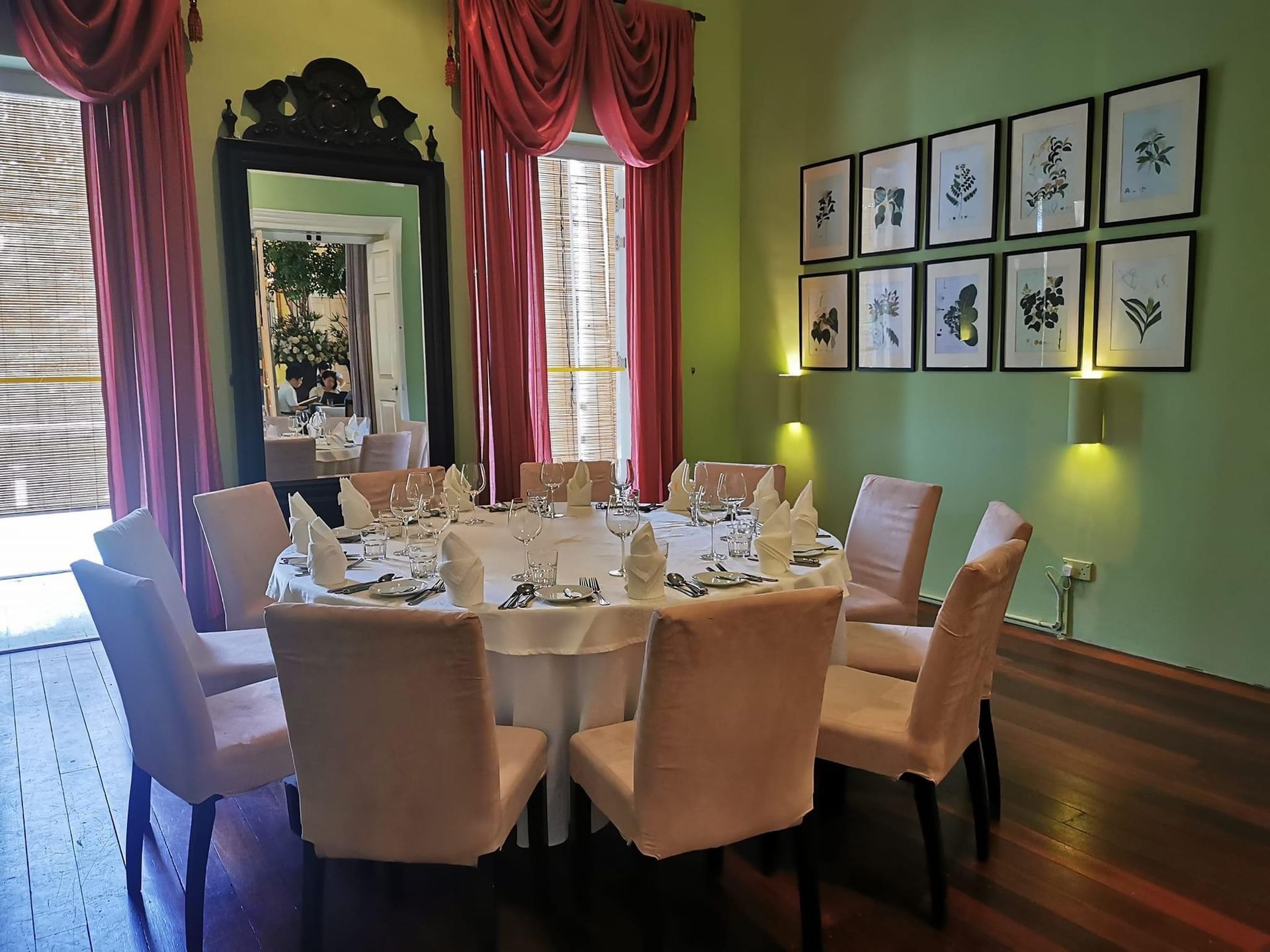 A dining room with a round table and chairs