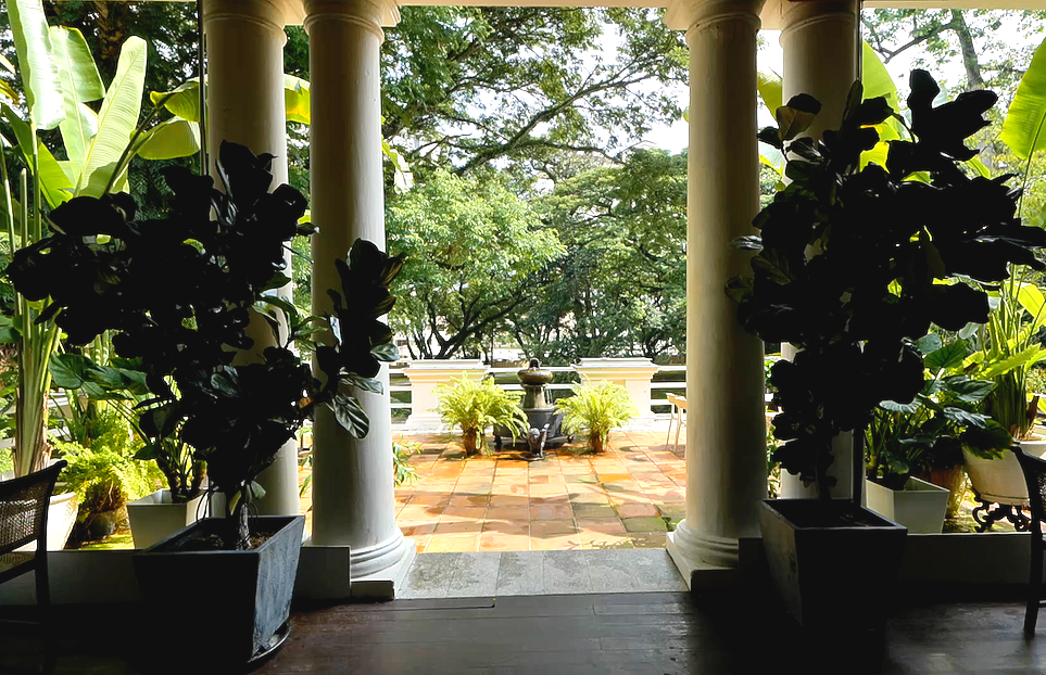 Colonnaded verandah and garden grounds at Suffolk House Penang