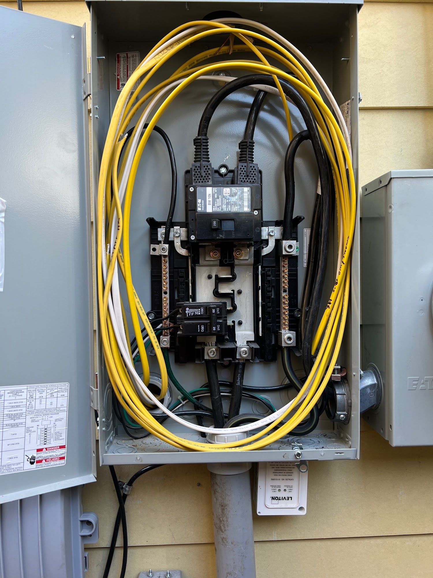 Electrical panel with yellow and black wires.