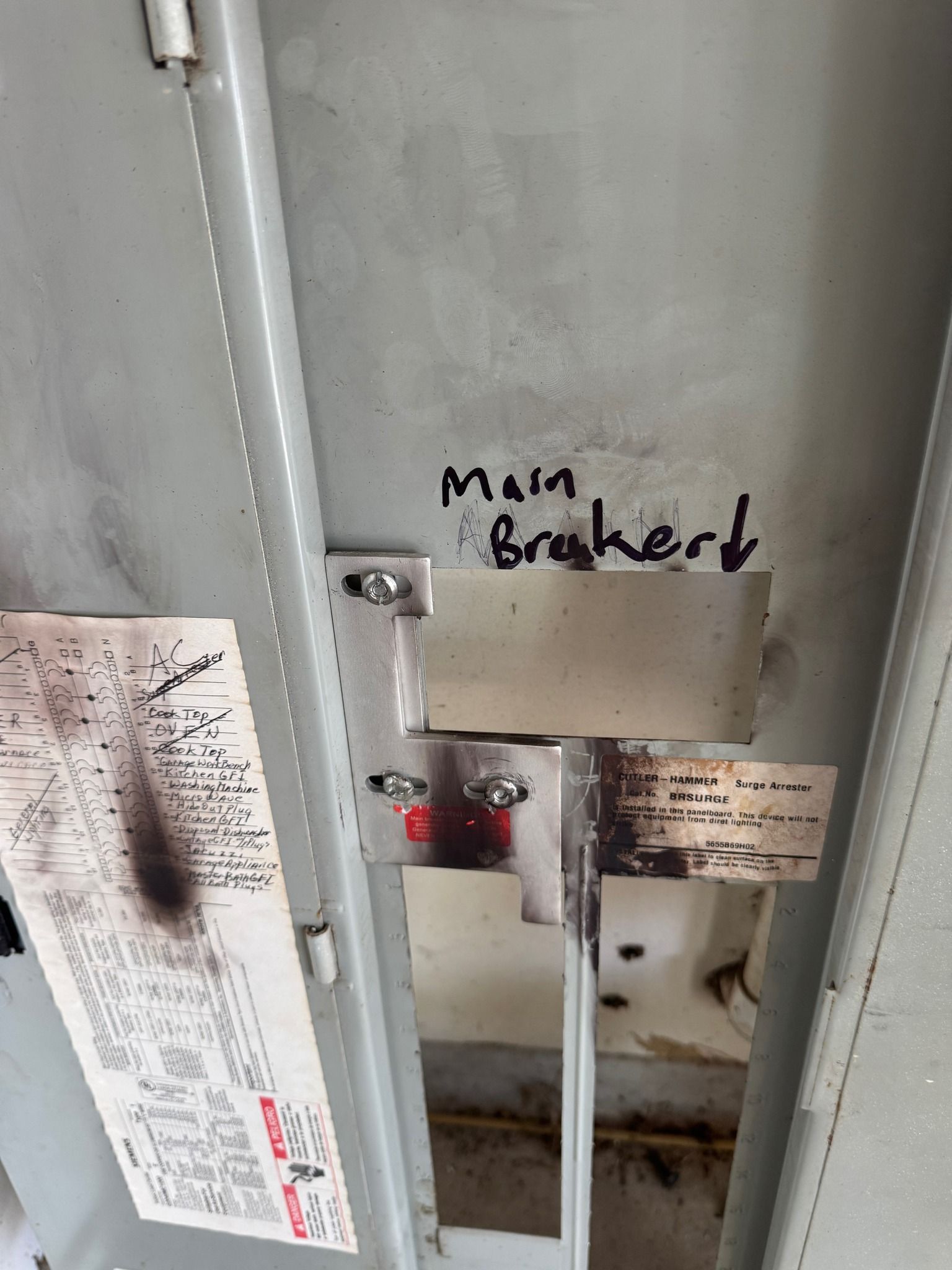 Interior of an electrical panel with handwritten 