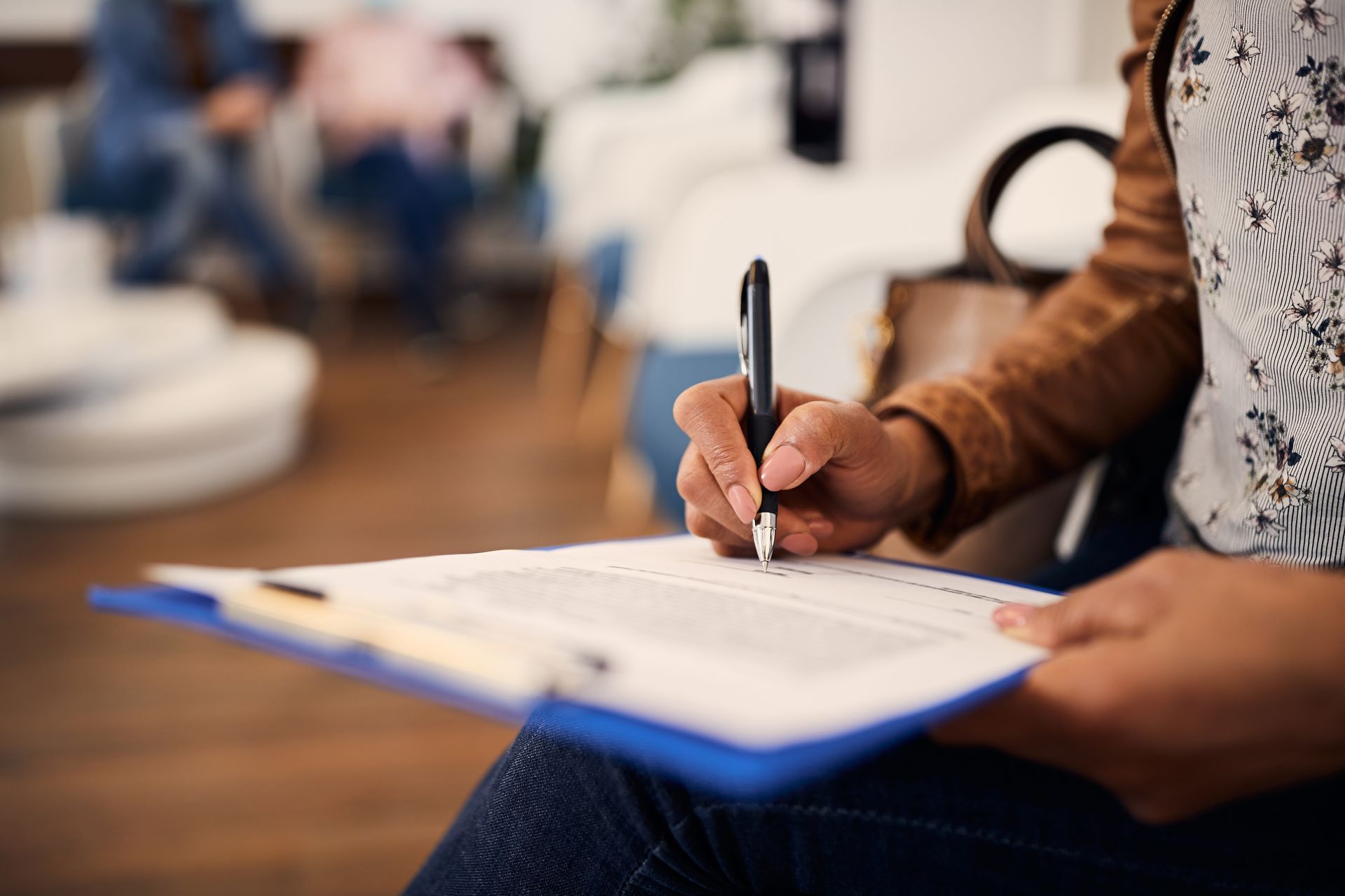 Patient filling out an insurance form at a dentist's office Patient filling out an insurance form at a dentist's office