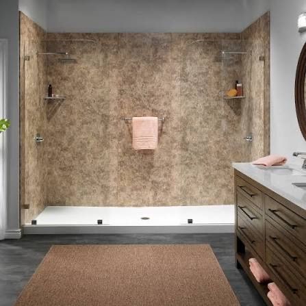 Modern walk-in shower with textured brown walls, white floor, and glass panels next to a dark wood bathroom vanity.
