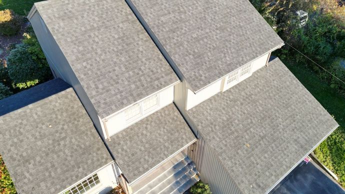 A close up of the side of a house with a light on it.