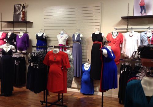 A variety of dresses are displayed in a store