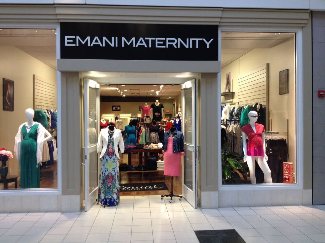 A store called emani maternity with mannequins in front of it