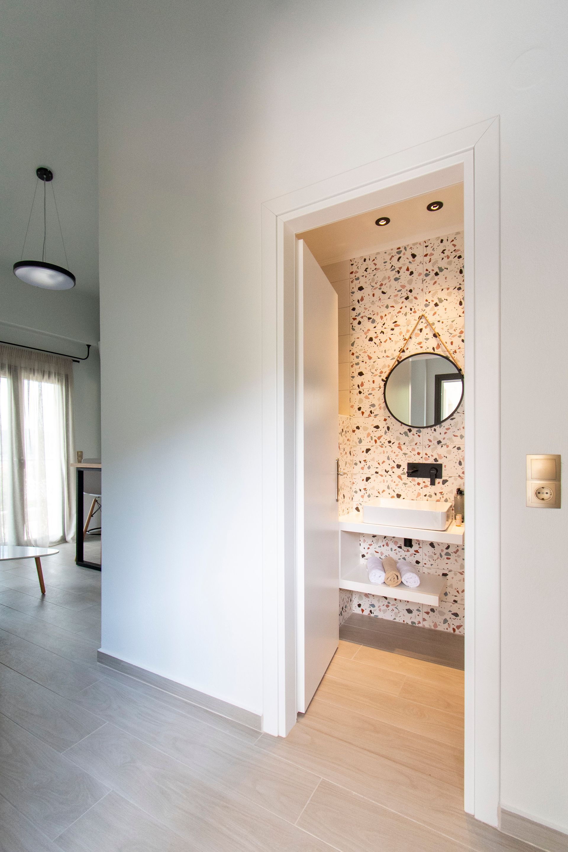 A bathroom with a sink and a mirror on the wall.